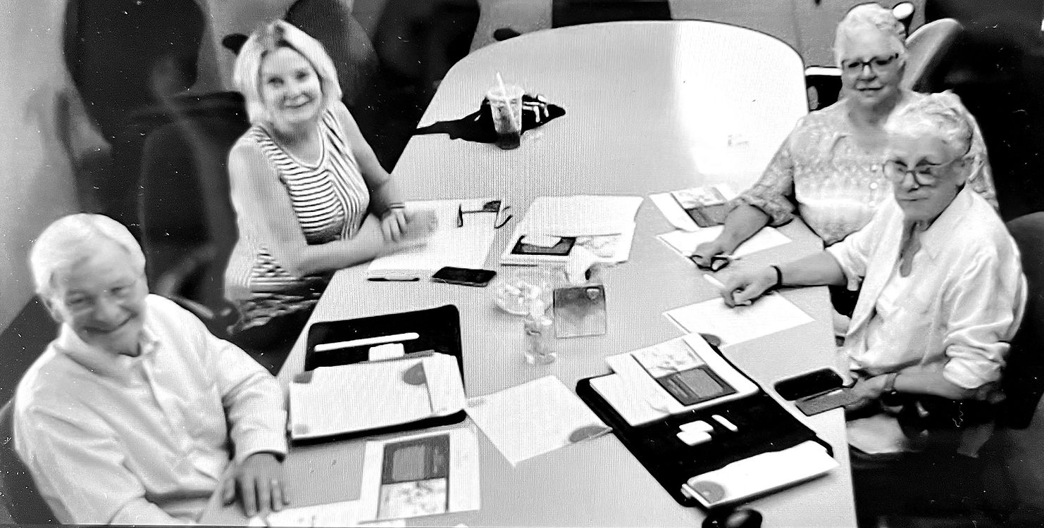 Members of The Mary Grace Hospice Foundation board seated around a table at a meeting