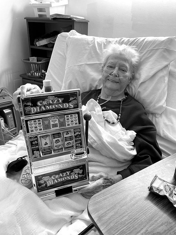 A patient in bed with a slot machine game she received as a comfort item