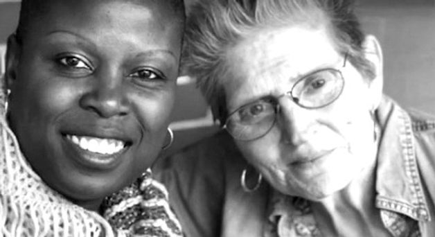 A caregiver and patient smiling together
