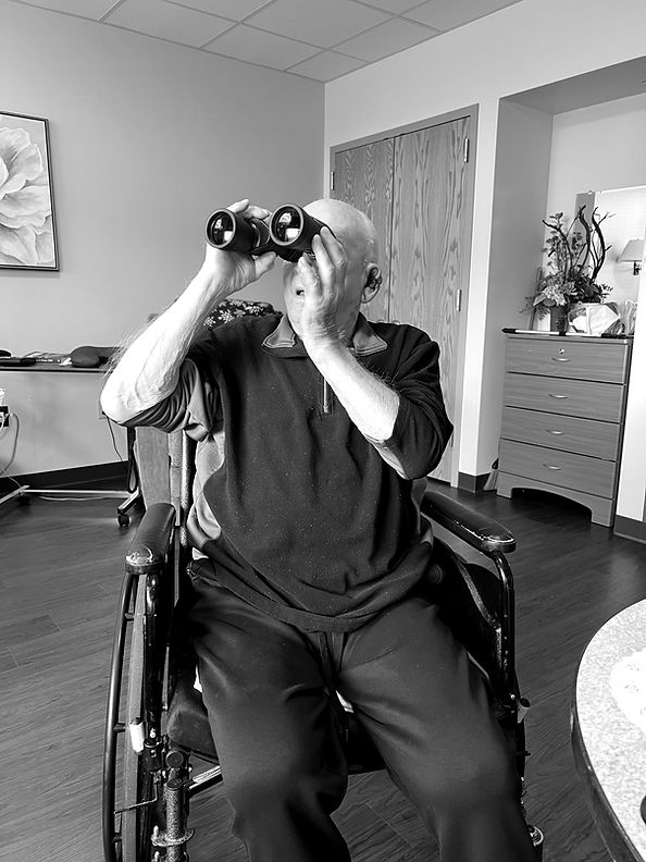 A patient using a pair of binoculars received through the foundation