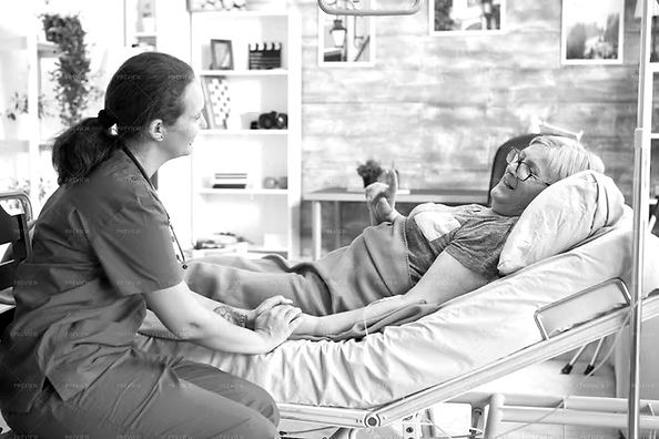 A nurse at the bedside of a patient receiving care at home