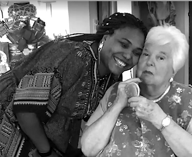 A caregiver holding a patient's hands in comfort